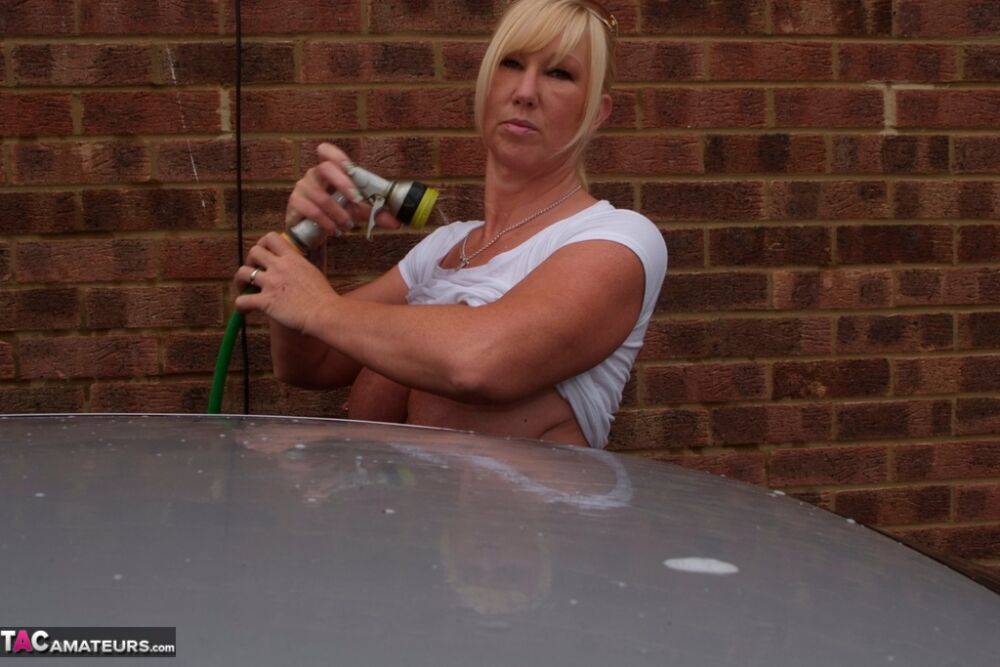 Big titted blonde amateur Melody soaks a white T-shirt while washing her car - #12