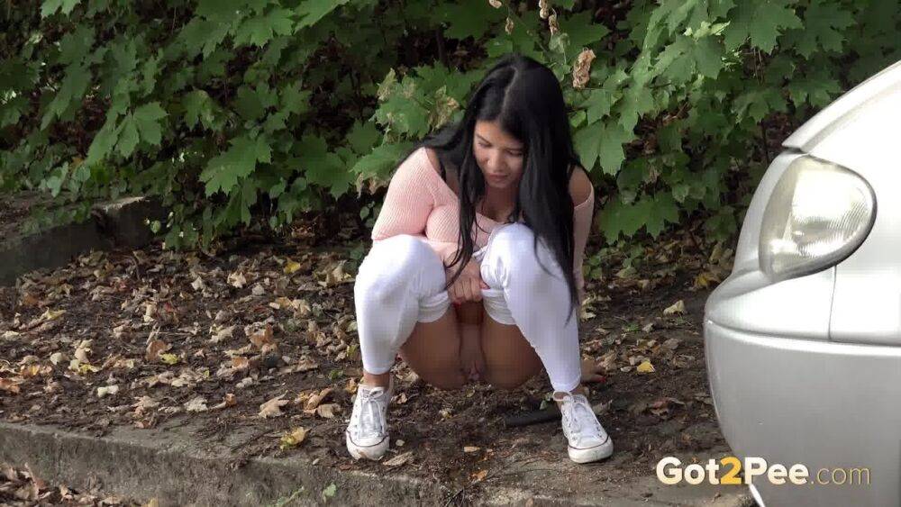 Dark haired girl Dee pulls down her white leggings for quick pee behind bushes - #12