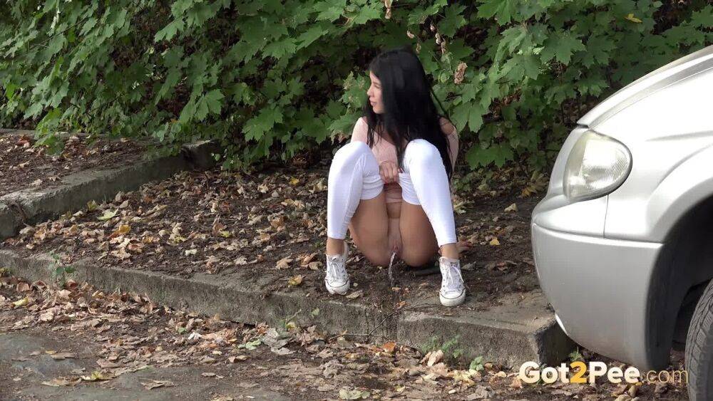 Dark haired girl Dee pulls down her white leggings for quick pee behind bushes - #2