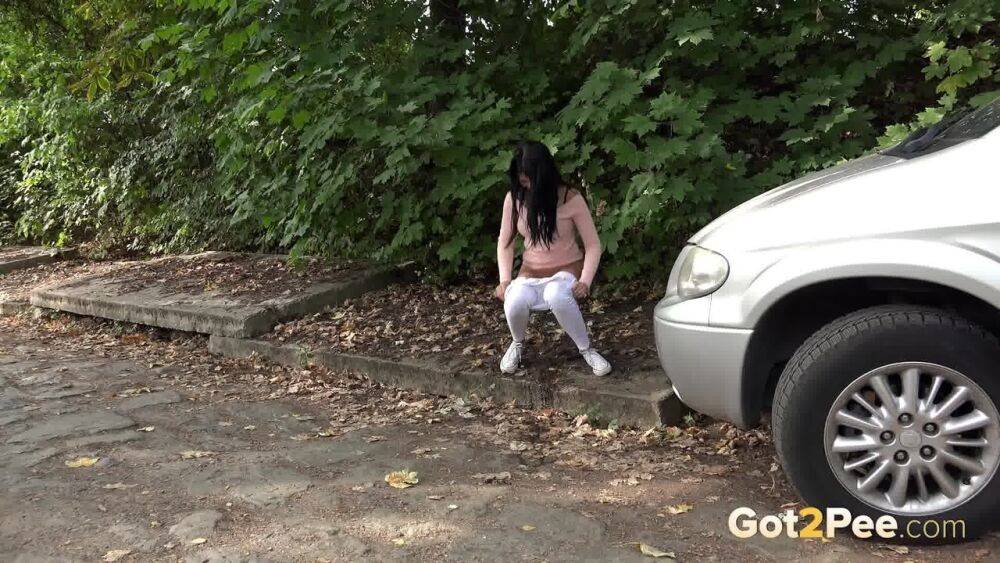 Dark haired girl Dee pulls down her white leggings for quick pee behind bushes - #5