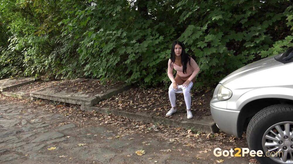 Dark haired girl Dee pulls down her white leggings for quick pee behind bushes - #6