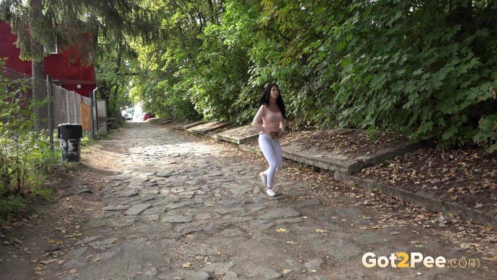 Dark haired girl Dee pulls down her white leggings for quick pee behind bushes - #11