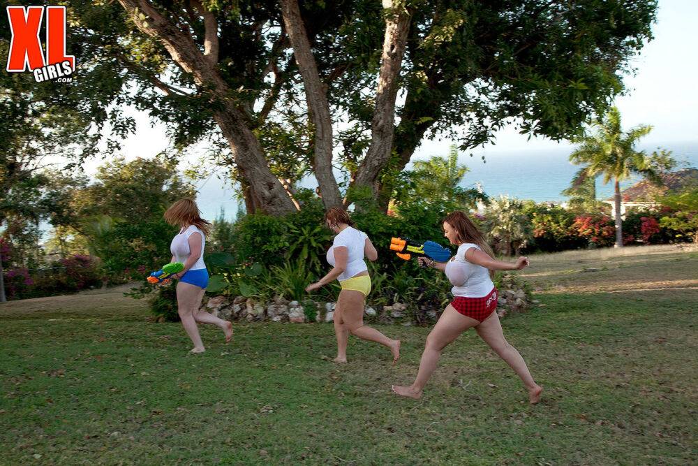 Big titted girls soak white t-shirts in a yard with super-soaker water guns - #12