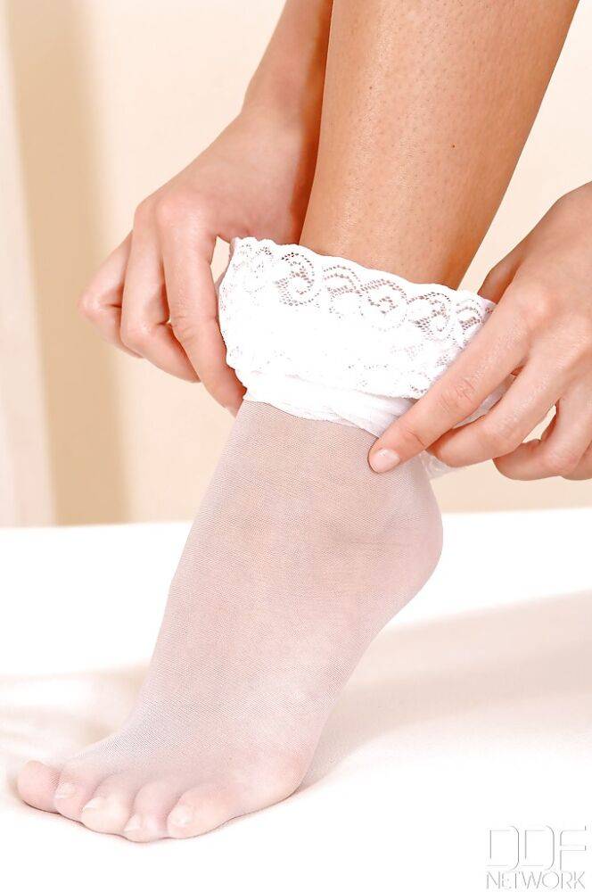 Leggy MILF Veronica da Souza removing white stockings from sleek legs - #8