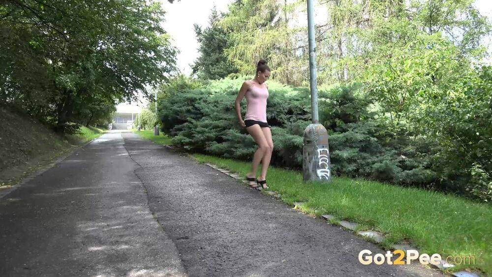 White girl hitches up her skirt to take a much needed pee outdoors - #15