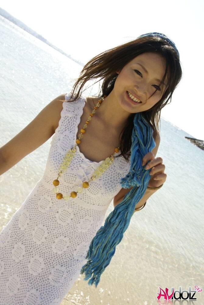 Asian girl wander into the ocean to her knees in a white dress - #1