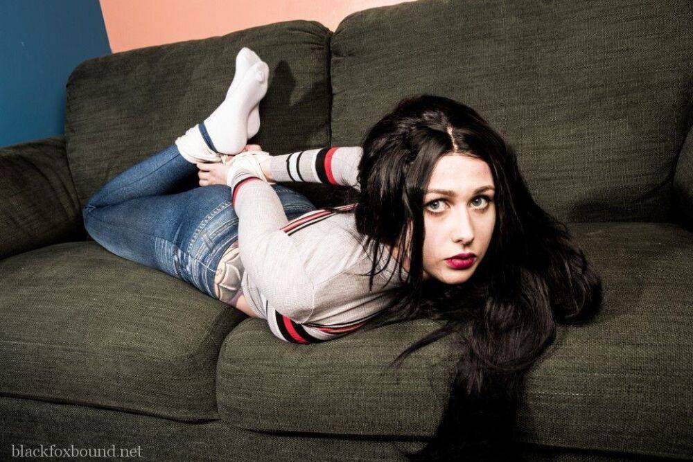 Dark haired chick is hogtied on a couch while closed in jeans and white socks - #15