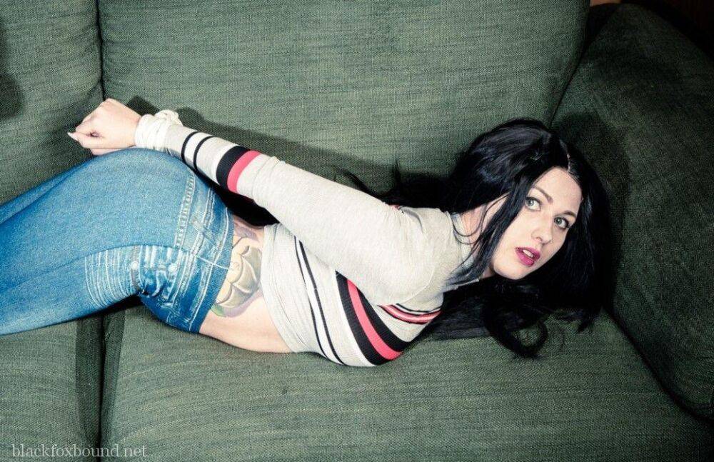 Dark haired chick is hogtied on a couch while closed in jeans and white socks - #4