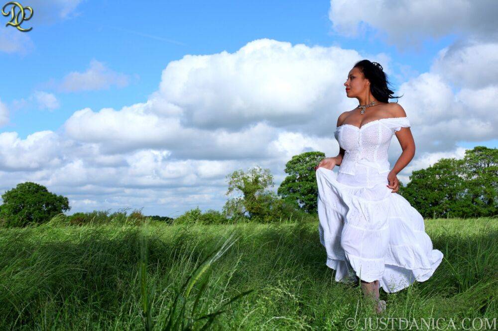 Mature lady Danica Collins looses her large tits from a white dress in a field | Photo: 3727326