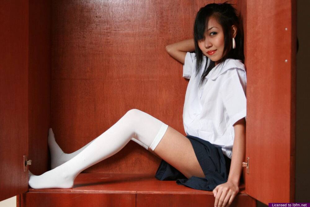 Cute Asian student showcases her bald cunt on a shelf in white OTK socks - #2