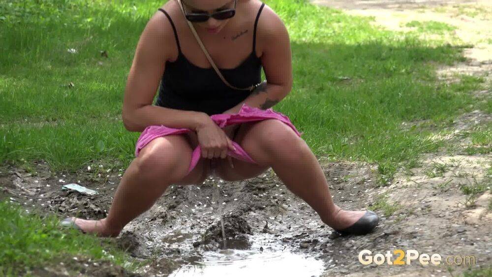 White girl Dafne pisses in a mud puddle while out for a walk in sunglasses - #15