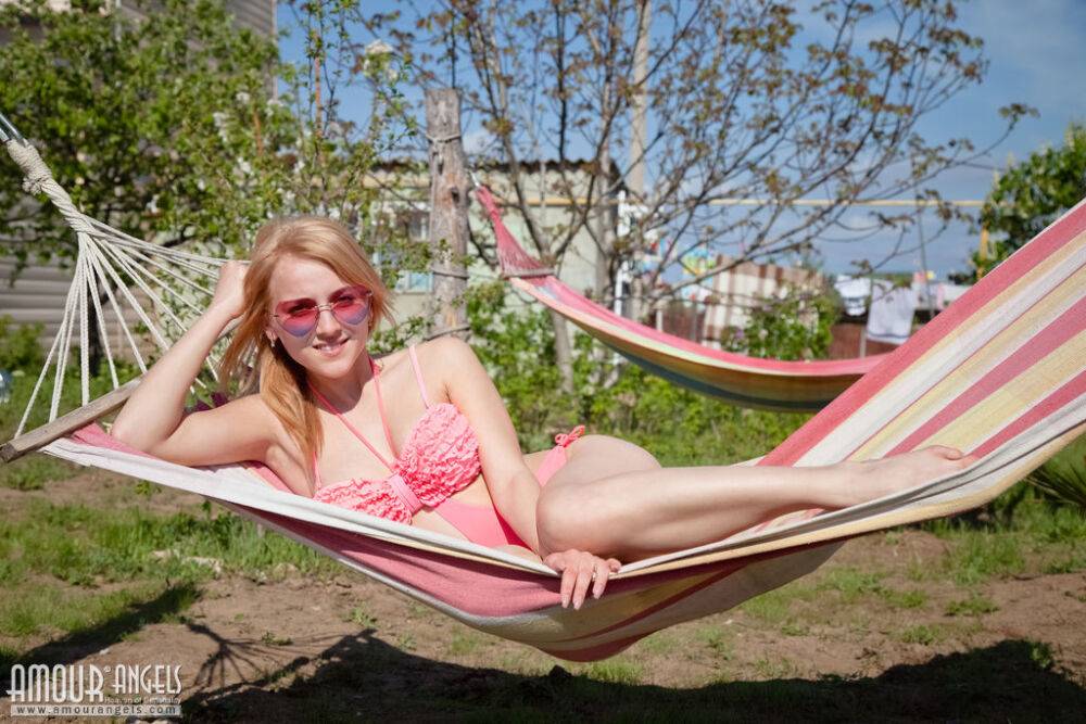 White teen Gloria removes swimwear to pose nude on a hammock - #3