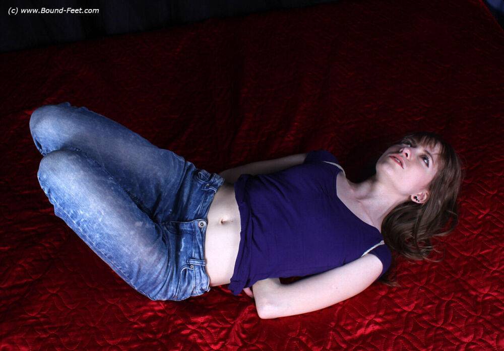 Barefoot white girl Agnes is hogtied in a shirt and blue jeans - #9