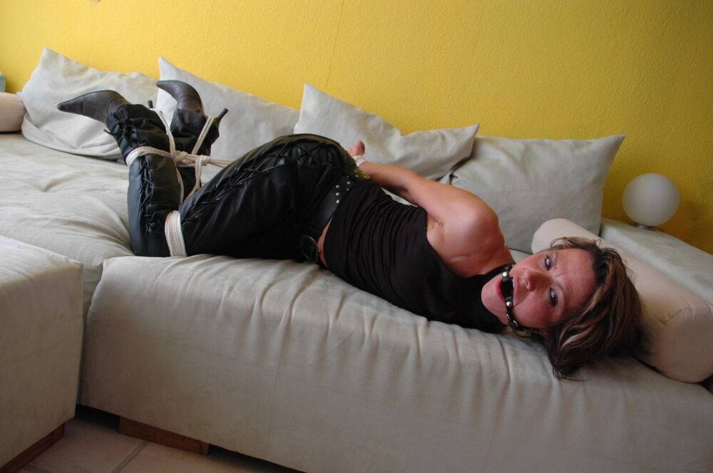 White chick struggles against a ball gag and rope bindings in leather pants - #14