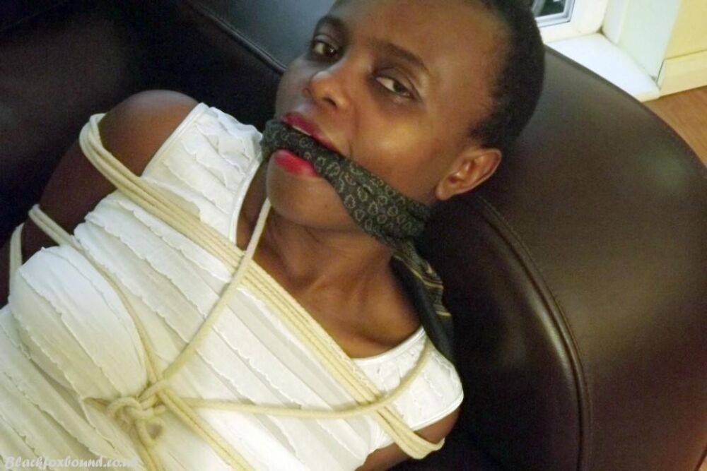 Black female is left tied and cleave gagged in a white dress on a leather sofa - #13