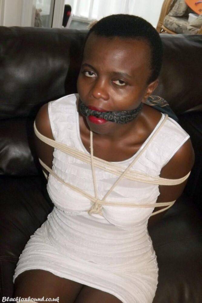 Black female is left tied and cleave gagged in a white dress on a leather sofa - #12