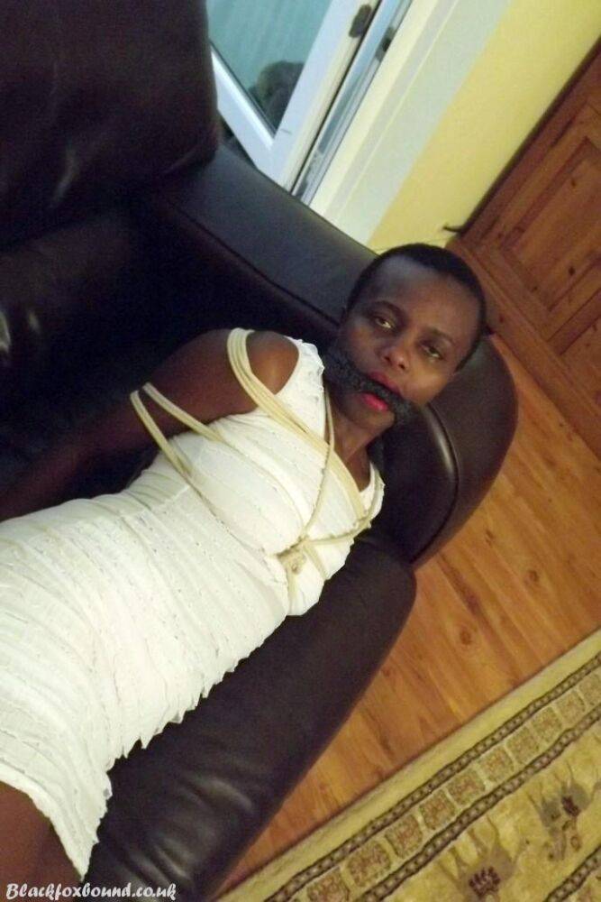 Black female is left tied and cleave gagged in a white dress on a leather sofa - #9