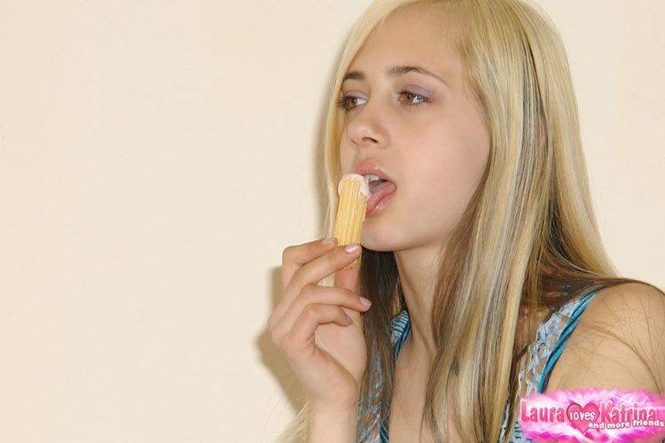 Young blonde girl sucks a finger after eating corn dipped in white goo - #2