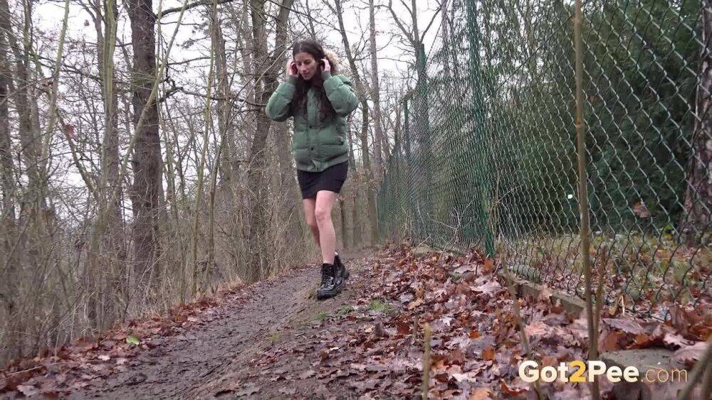 White girl Ali Bordeaux squats for a piss against a fence in a winter coat - #3