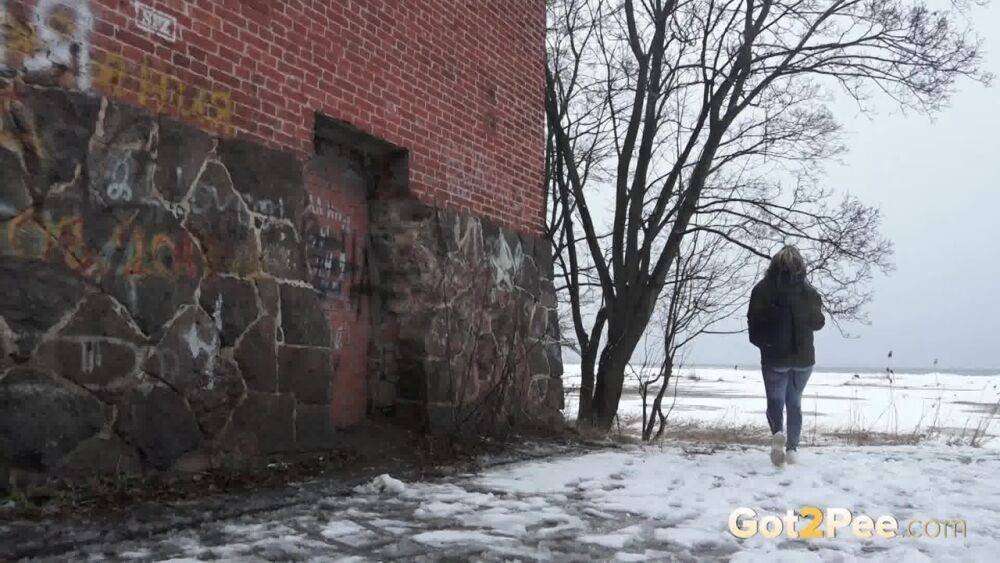 White girl pulls down her jeans for a badly needed pee on snow-covered ground - #12