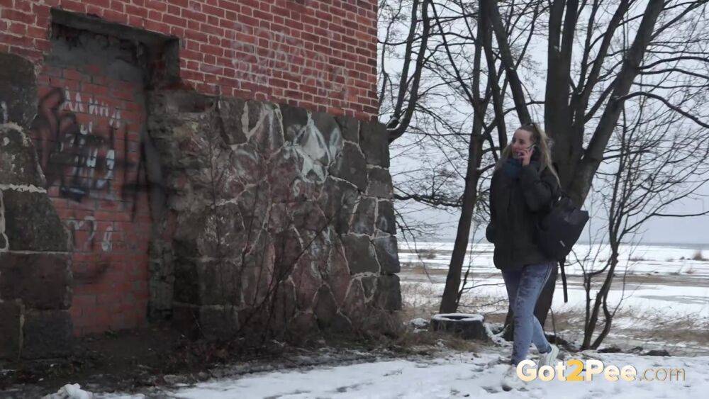 White girl pulls down her jeans for a badly needed pee on snow-covered ground - #5