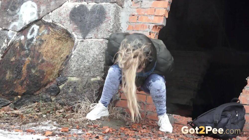 White girl pulls down her jeans for a badly needed pee on snow-covered ground - #14