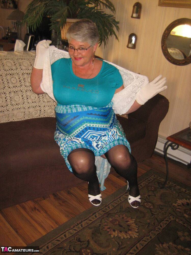 Fat Oma Girdle Goddess wears white gloves while disrobing to a bra and girdle - #11