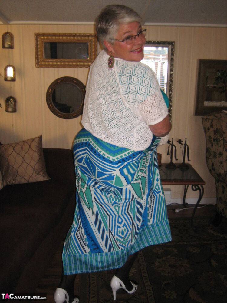 Fat Oma Girdle Goddess wears white gloves while disrobing to a bra and girdle - #8