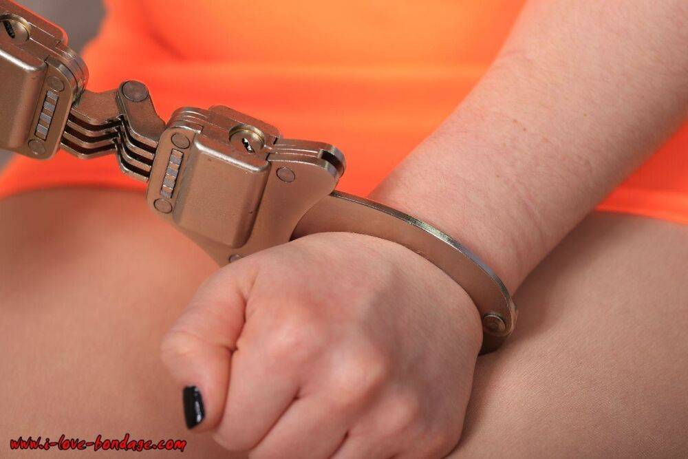 White girl in prison clothing and shoes is hogtied with hand and ankle cuffs - #14