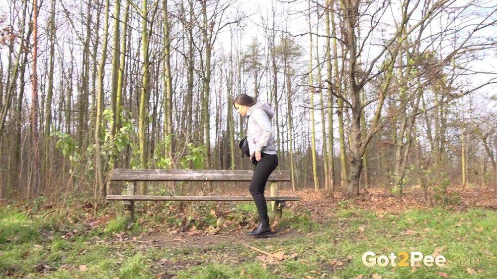 White girl Lara Fox squats for a piss near a park bench in black leggings - #6