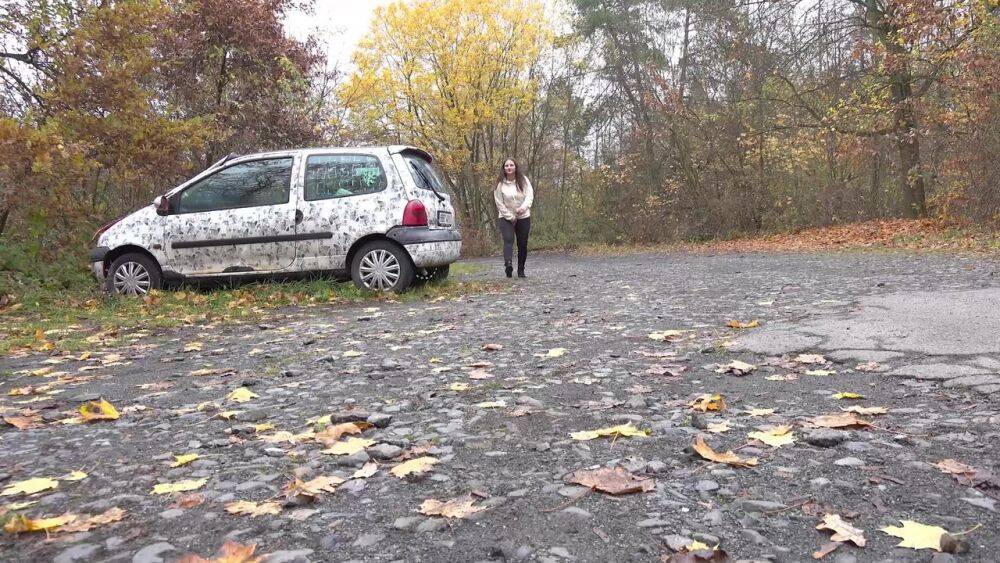 White girl Nicolette Noir takes a piss beside a parked car in a wooded setting - #8