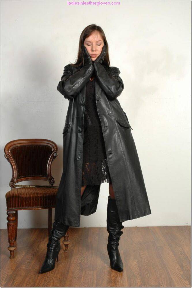 Brunette female dons long leather coat in leather boots and stockings - #2