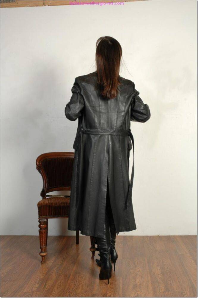 Brunette female dons long leather coat in leather boots and stockings - #3