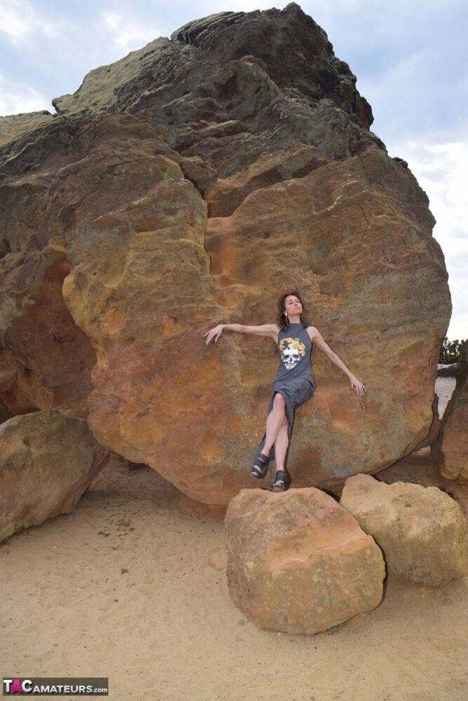 Amateur model exposes her vagina during upskirt action on rust stained rocks - #13