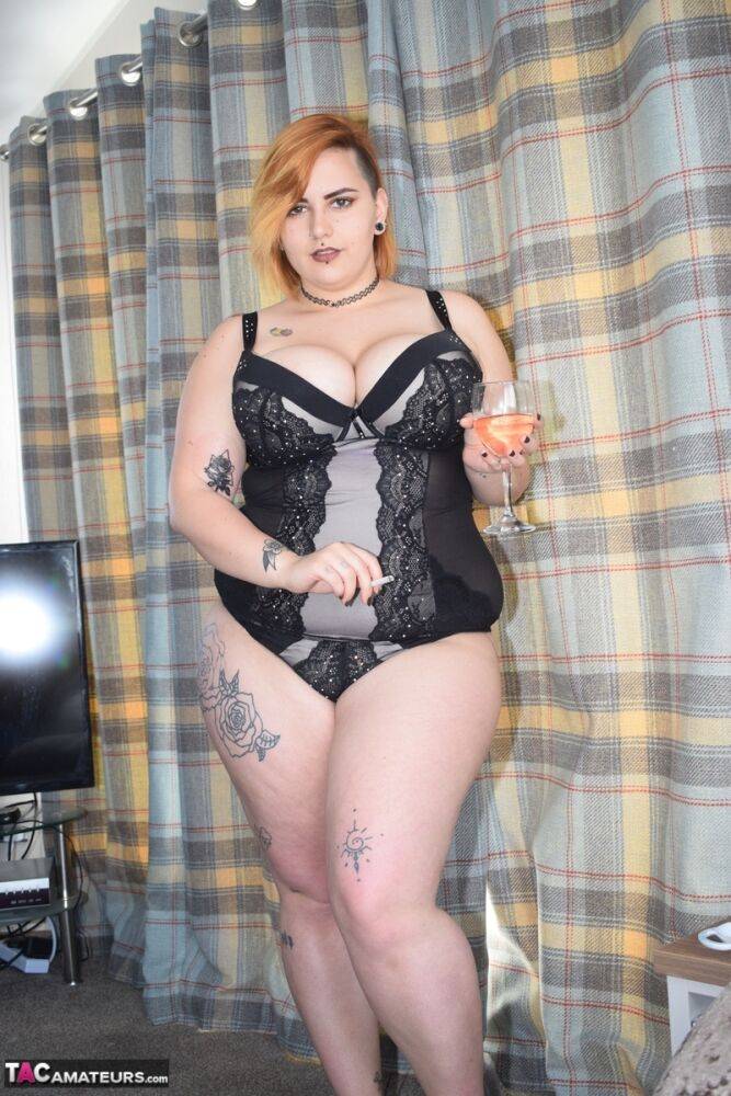 Tattooed BBW smokes and drinks while peeling off her lingerie - #2