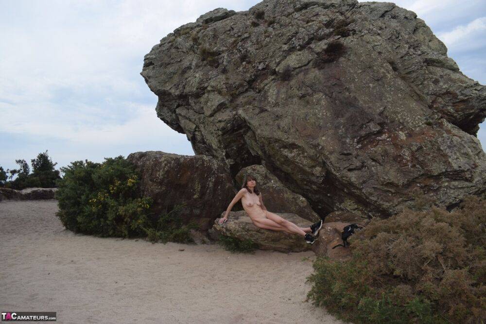 Amateur chick poses totally nude in running shoes near huge boulders - #15