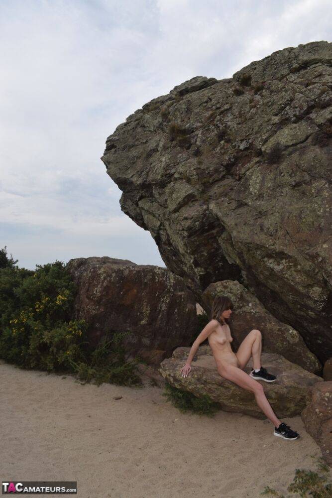 Amateur chick poses totally nude in running shoes near huge boulders - #12