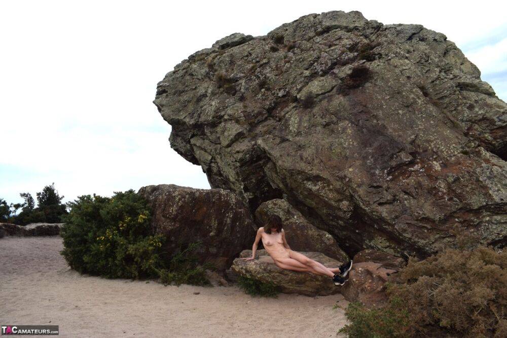 Amateur chick poses totally nude in running shoes near huge boulders - #10