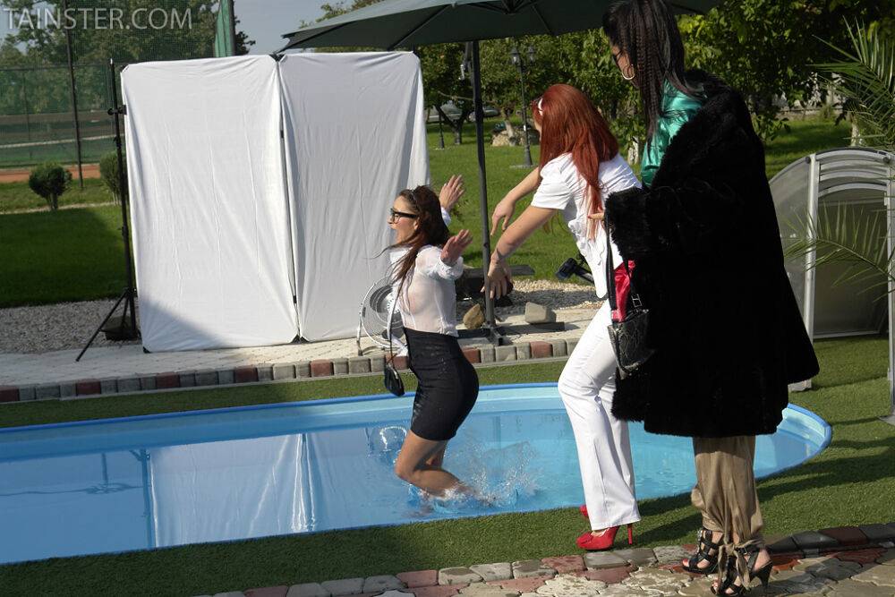 Clothed ladies jump into a pool before showing off their bare breasts - #10