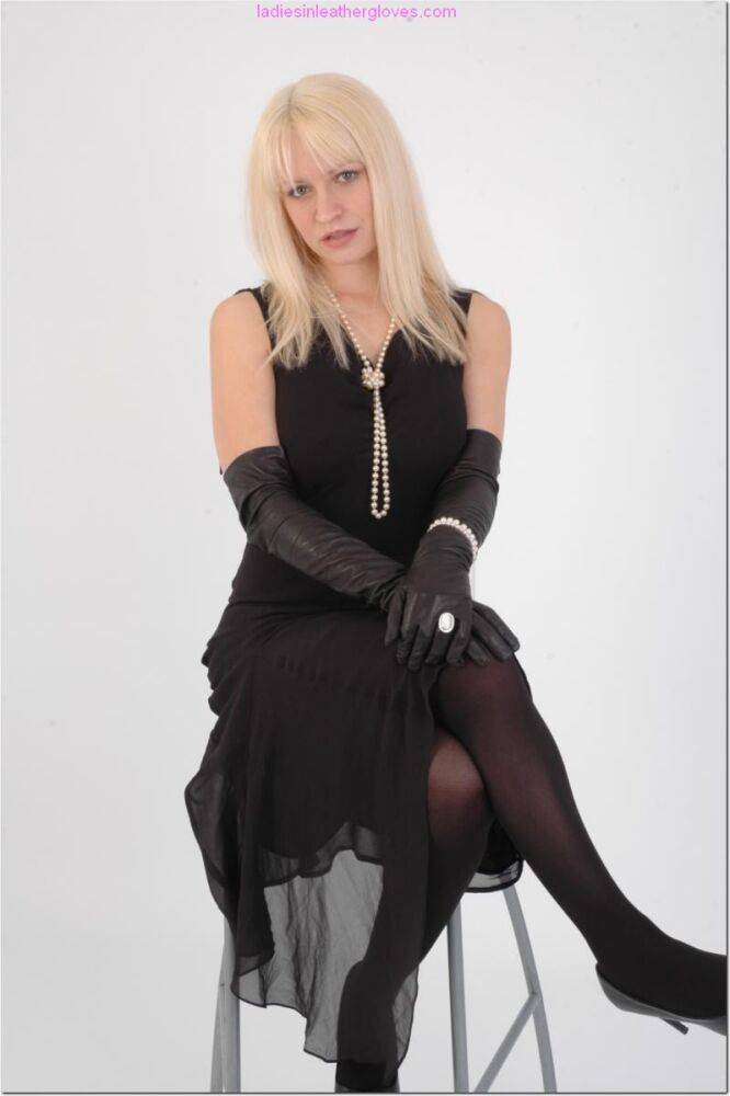 Natural blonde exposes some thigh while wearing long leather gloves - #8