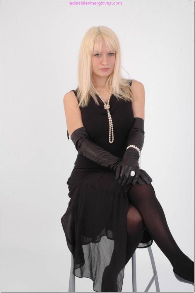 Natural blonde exposes some thigh while wearing long leather gloves - #9