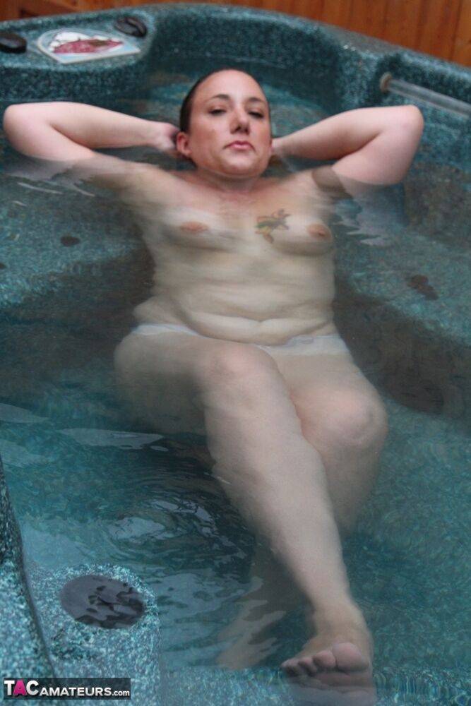 Mature redhead displays her plump body while naked in an outdoor hot tub - #16