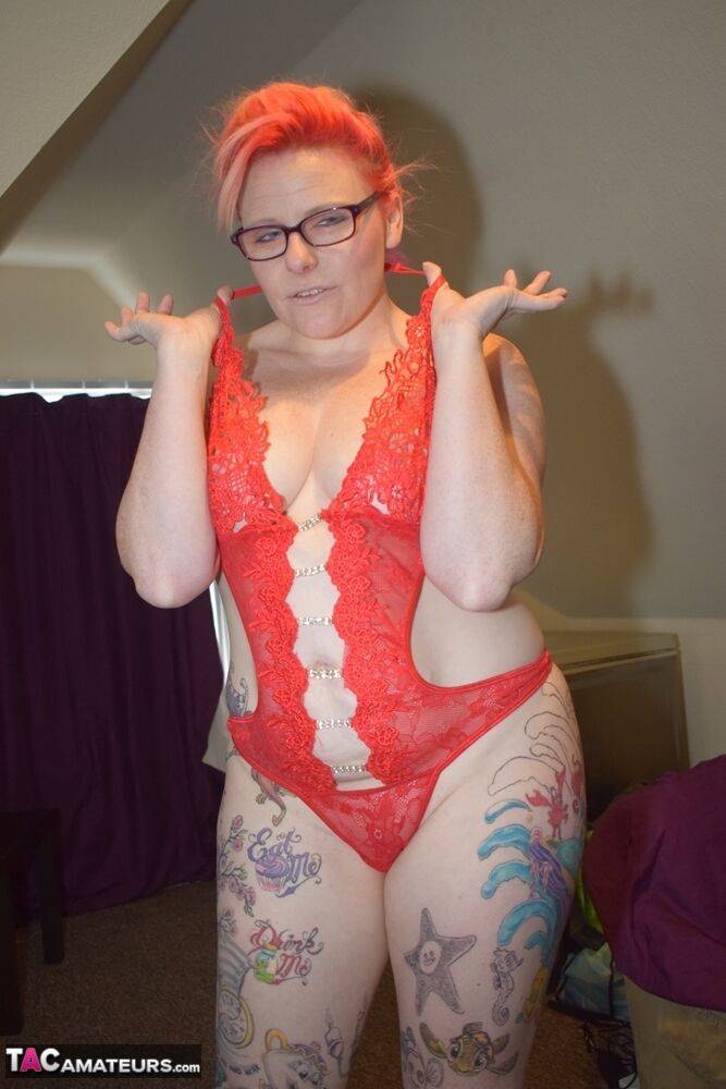 Inked amateur slips off red lingerie to pose nude in glasses and heels - #7