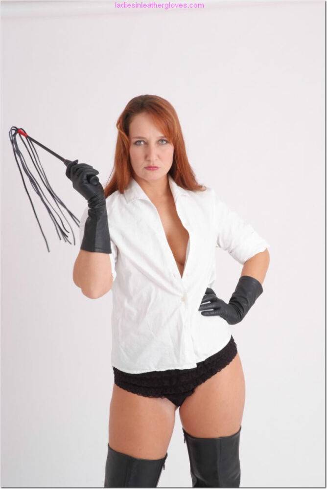 Natural redhead wields a flogger in leather gloves and thigh high boots - #3