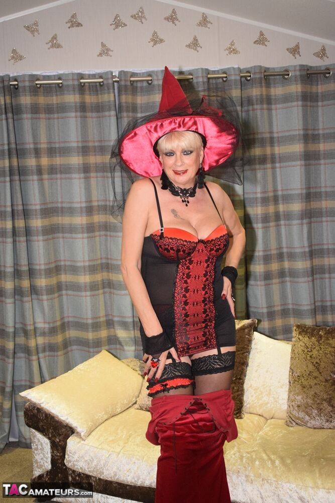 Older blonde removes a red velvet dress pose nude in a witch's hat and hosiery - #9