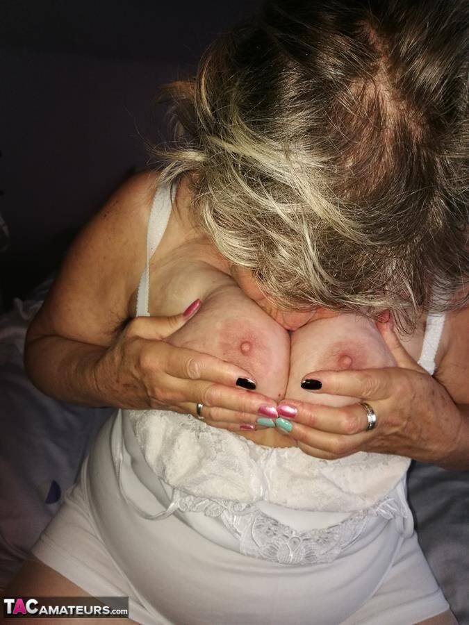 Naughty granny exposes her boobs while changing attire in nylons and heels - #16