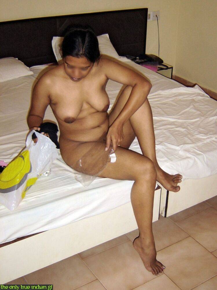 Naked Indian wife pulls on black nylons and garters on edge of bed - #3