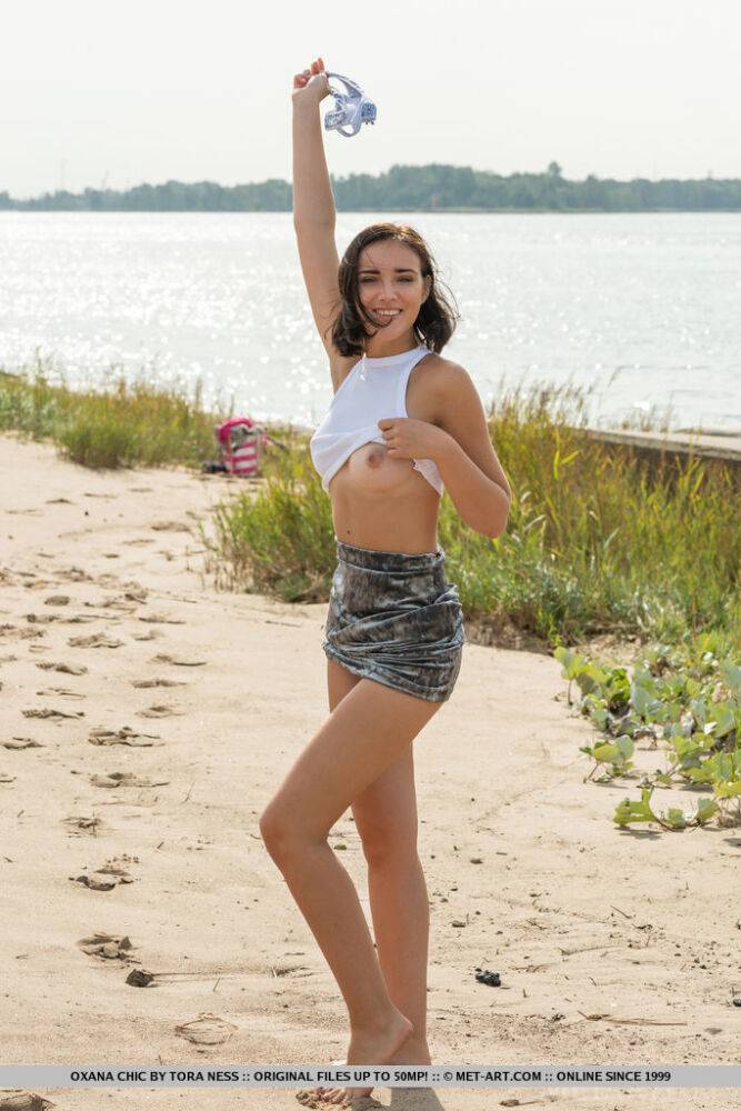 Teen solo girl Oxana Chic grabs her bare ass after disrobing at a public beach - #7