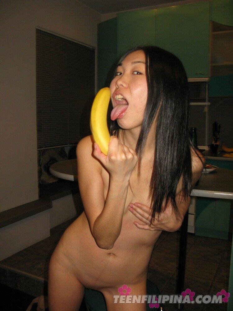 Skinny Filipina teen Nicoline Yiki fools around with a banana while bare naked - #11