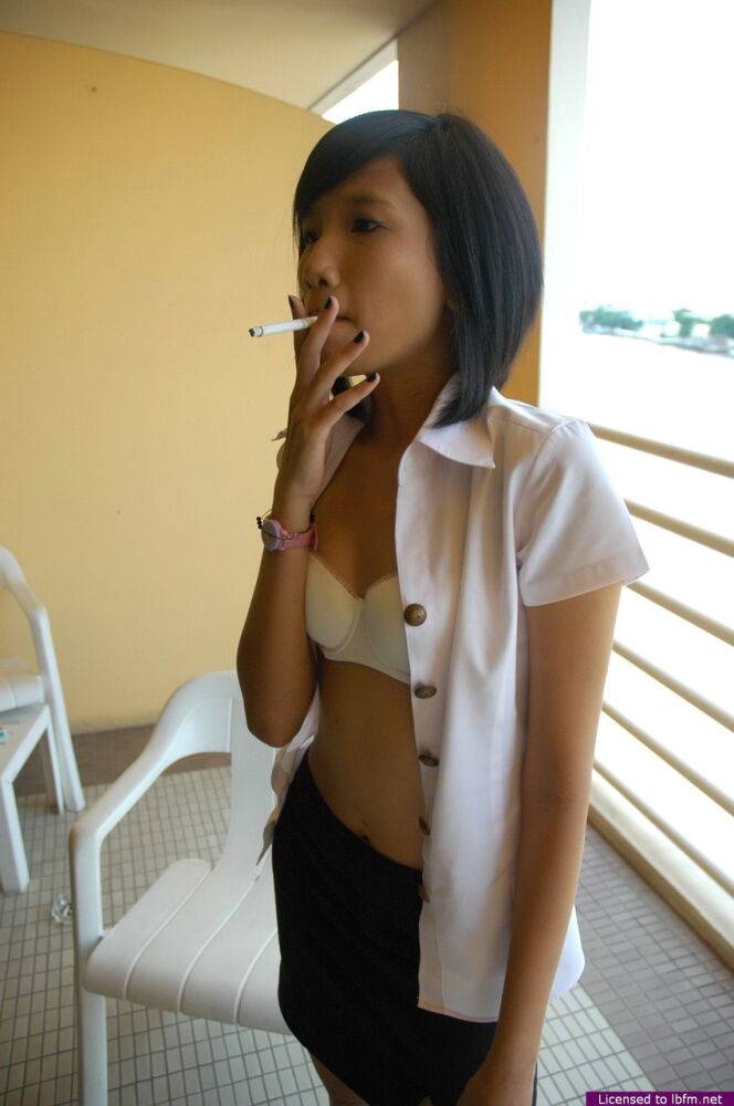 Young Asian girl smokes a cigarette before making her nude modeling debut | Photo: 3947263